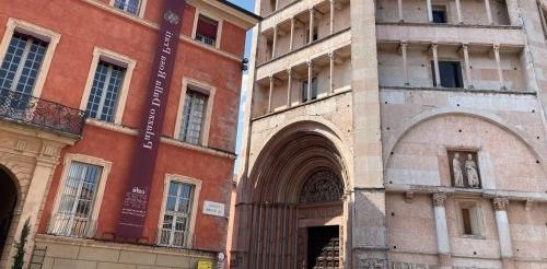 Photo of the historic center of Parma with pink and red buildings